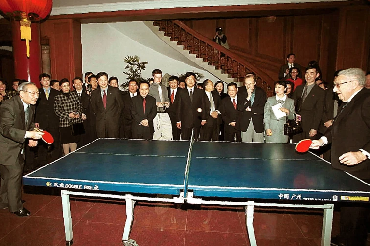 Henry Kissinger plays table tennis with China's then vice premier Li Lanqing at the Diaoyutai State Guesthouse in Beijing in 2001.