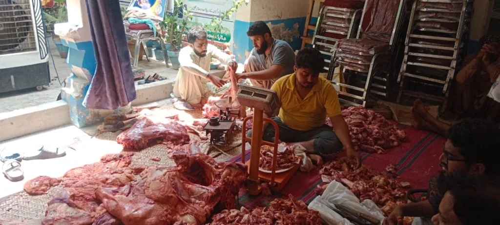 The welfare team distributes sacrificial meat.